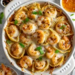 Overhead view of baked honey garlic shrimp pasta shells in a dish
