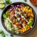 A beautifully plated serving of Street Corn Chicken Bowl with natural lighting on a clean background.