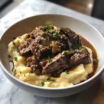 Photo of featured for Heavenly Tender Short Rib Ragu Poured Over Creamy Parmesan Mashed Potatoes